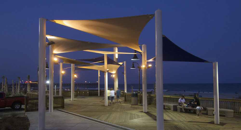 Commercial shade structures and systems to provide elegant shade and protection from the elements